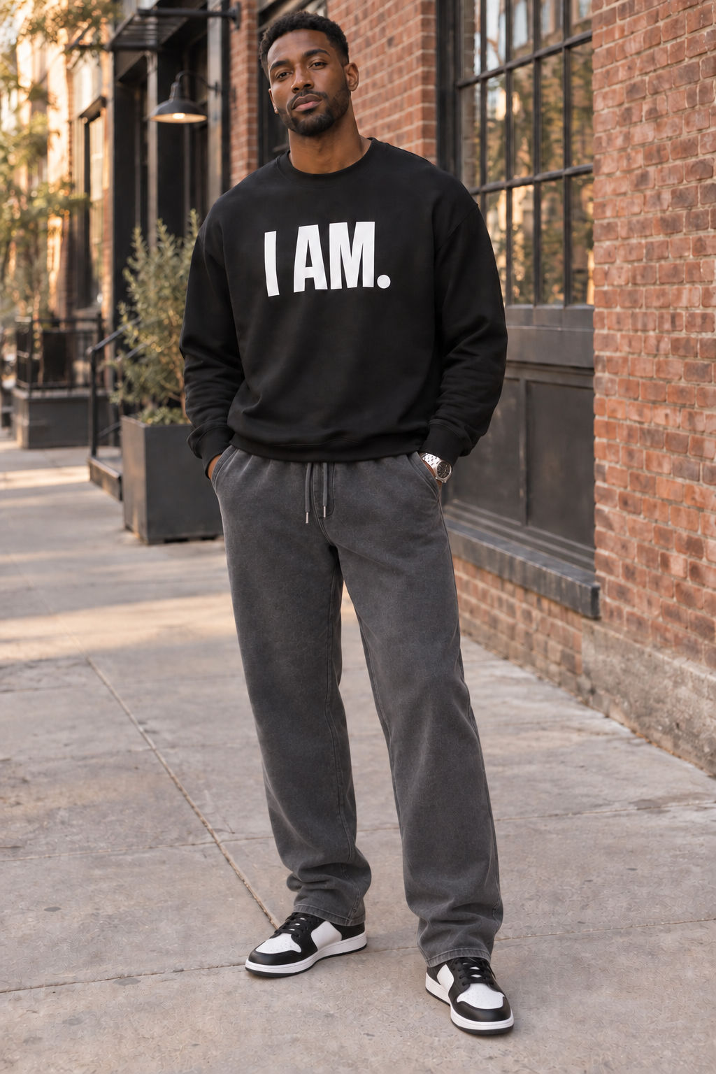Man wearing the black I AM. statement crewneck sweatshirt